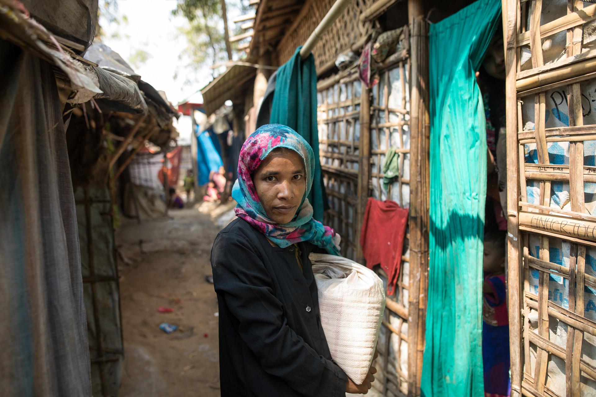 A Rohingya woman walks through an alley in the camps. There are some 900,000 refugees in Bangladesh.