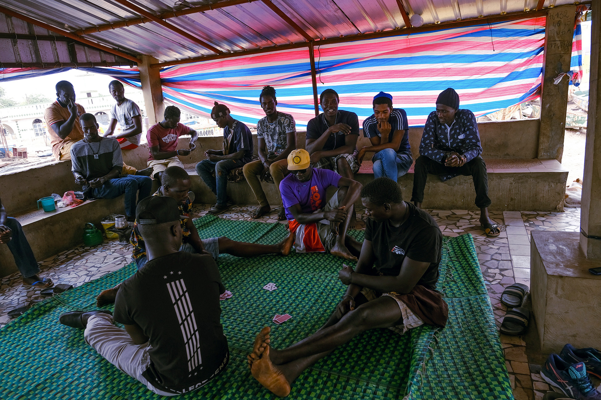 A group of young men who work on fishing boats take a break and play cards