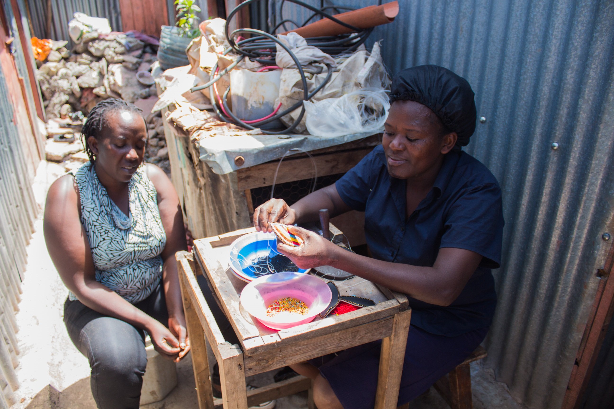 Resident Christine Wayua strings beads in Mukuru