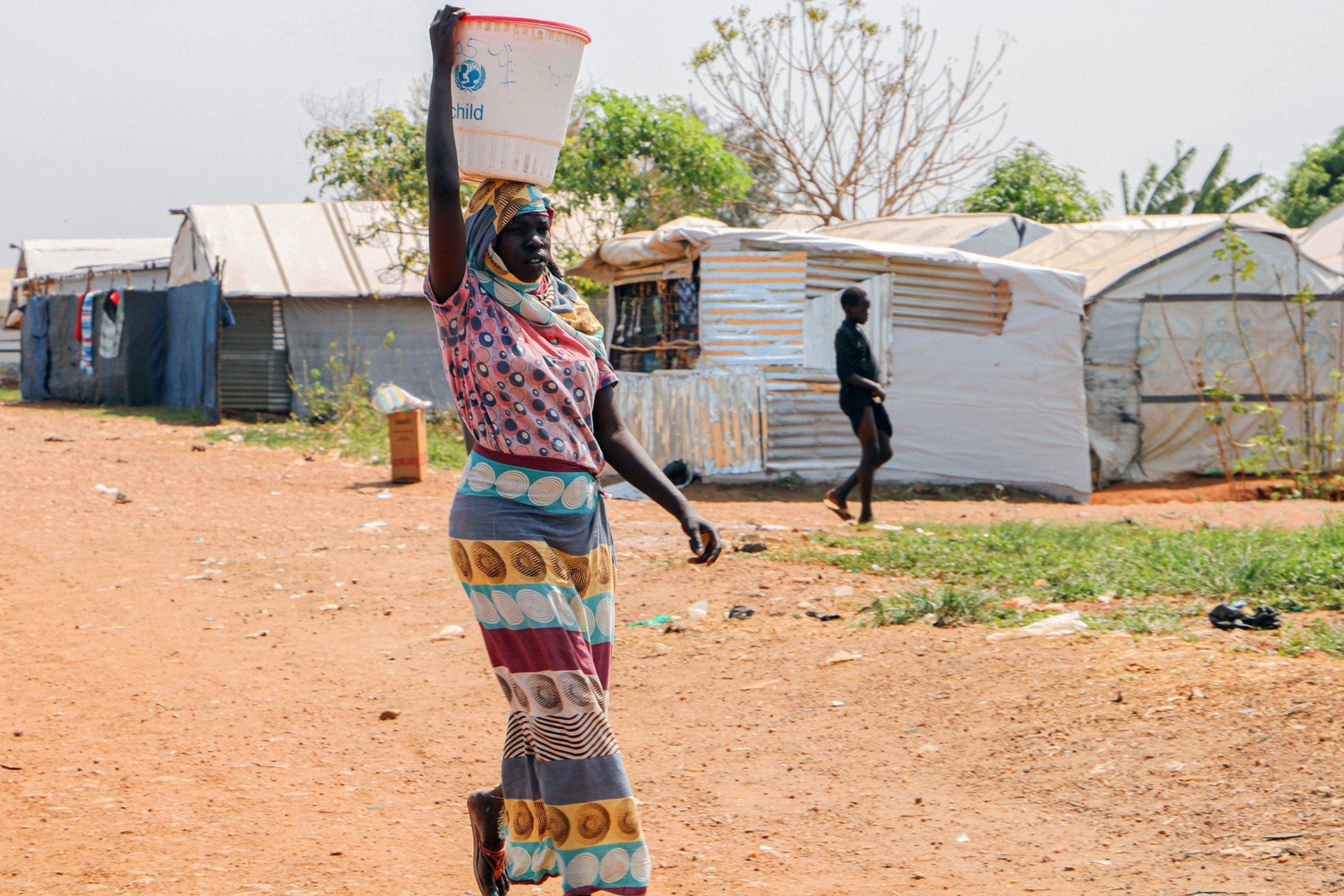 A woman walks through a displacement camp once guarded by UN peacekeepers in Juba. Sudanese security forces responsible for the camp are distrusted by residents