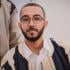 This is a headshot of Ala Majid Khayrullhah. He is a passionate medical student and activist working to raise green awareness from Sirte, Libya. He is pictured sitting down, looking at the camera.