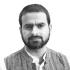 This is a headshot of Imran Muzaffar. He is pictured looking at the camera without smiling.