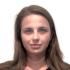This is a headshot of Sasha Filippova. She is pictured smiling slightly at the camera, not showing teeth. She wears a dark-colored blouse.