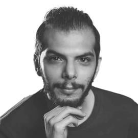 A headshot of Amer al-Meri. He pis picture looking at the camera his right hand rests on his chin.