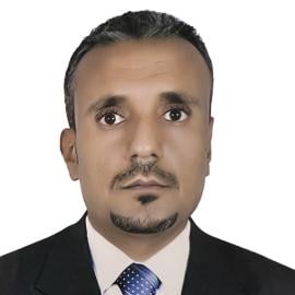 A headshot of Saeed al-Batati. He is pictured looking at the camera, not smiling, wearing a dark suit and blue tie.