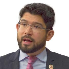 A headshot of Carlos Menchaca mid-speech.
