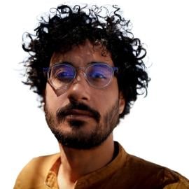 This is a headshot of Nour Khalil. He is pictured looking at the camera without smiling.