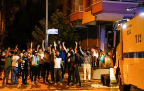 Men make the hand signal for a far-right Turkish group during August 2021 anti-refugee riots in Ankara. One of the first episodes flagging rising xenophobia in Turkey, the riots were marked by the targeting of Syrian properties and businesses.