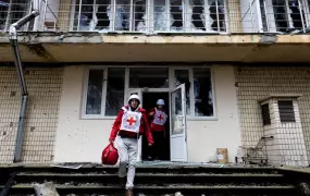 ICRC staff walk out of a damaged building in Irpin, Ukraine on 1 April 2022. The organisation's response to the war has been embroiled in controversy surrounding accusations of bias and the optics of neutrality.