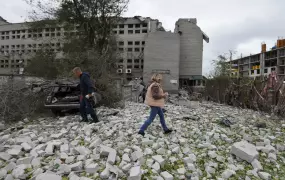 Residents walk at the site of a building damaged by a Russian missile strike in Dnipro, Ukraine on 10 October. Russia's war appears to be entering a dangerous and unpredictable new phase.