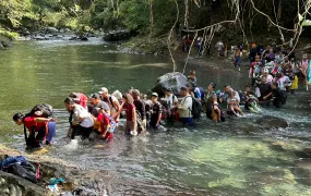 Migrants crossing a river in the Darién Gap. They must do so dozens of time along the route.