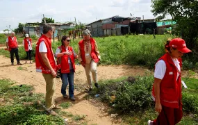 Charlotte Slente, secretary general of the Danish Refugee Council (DRC), and other DRC staff walk through a migrant neighbourhood in Riohacha, Colombia, in December 2024.