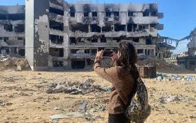 Rita Baroud is pictured taking a photo with her cellphone of what remains of Gaza City's Al-Shifa hospital.