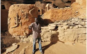 Malian journalist Mamadou Tapily speaks to tourists while working as a guide before a jihadist insurgency swept through large parts of his country from 2012 onwards.