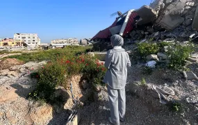 Nour overlooks her neighbourhood after returning to Gaza City during the ceasefire after spending over a year forcibly displaced.