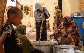 Sudanese volunteers prepare meals for people affected by conflict and extreme hunger in the city of Omdurman, on 20 June 2024. 