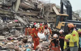 A picture of search and rescue forces in front of a collapsed building in Myanmar on April 02, 2025.