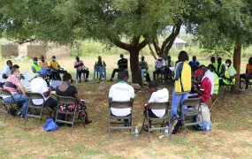 Refugee leaders sit outdoors at a meeting in Mpevi, western Uganda. R