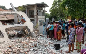People stand by a collapsed building after a strong earthquake, near its epicenter, in Sagaing, Myanmar, March 31, 2025. 