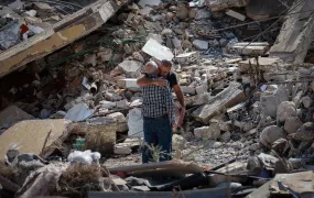 Two people hug as they stand on rubble of damaged buildings in the aftermath of Israeli strikes, amid the ongoing hostilities between Hezbollah and Israeli forces, in Joun village in the Chouf district, Lebanon November 13, 2024. 