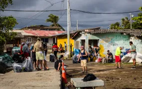 Venezuelan migrants wait near the pier in Miramar to begin the 8-hour boat ride to Puerto Obaldía, the first leg of their latest long journey, on 11 April 2025. 