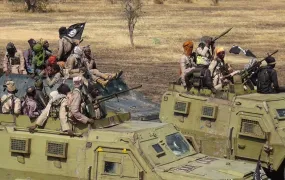 Islamic State West Africa Province (ISWAP) fighters display their looted Nigerian military vehicles.