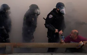 Police officers look at a demonstrator during a protest against federal immigration sweeps in downtown Los Angeles, June 8.