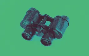 The image shows a pair of vintage binoculars placed on a flat surface against a solid background. The binoculars are black and appear heavily stylized with a blue duotone filter, giving them a bold, high-contrast appearance. The object casts a subtle blue shadow, enhancing the visual depth. The overall effect is artistic and graphic, with a pop art or retro-inspired aesthetic, focusing on the form and texture of the binoculars through heavy digital processing.