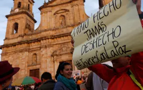 A woman holds a sign that reads, "Deal done, never undone", during a protest in support of the transitional justice body in Bogotá, Colombia, 13 March, 2019