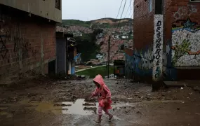 A child walks on the street of a slum in Soacha, on the outskirts of Bogotá, Colombia