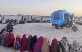 Children in Kandahar attend a class screened by Pen Path, an Afghan NGO that has been traveling to remote areas with its mobile school and library.