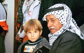 A Palestinian man and his grandson waiting to see a doctor in a West Bank Clinic.