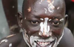 A young man performing a traditional dance at Namokora IDP camp, Kitgum district, northern Uganda, 15 May 2007. Kitgum is a sprawling settlement of 17,000 people.