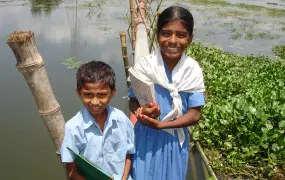 10-year Yasmin and her eight-year-old brother Rabbi, continue to attend classes at the Holan government primary school, north of Dhaka, despite monsoon floods. 