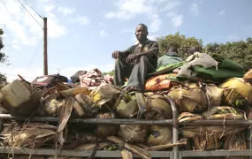 A man sits on top of a Sudan bound truck in Gulu.