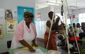 A nurse at Mbare poly clinic preparers to record the weight of a baby into the Child Health Card before they are vaccinated. All babies have to be weighed before they are vaccinated.