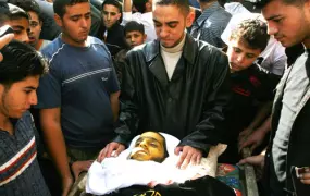 Relatives of Na'el al-Kurdi, 21, look at his body during his funeral in Gaza City on 17 November, 2007. Na'el, who suffered from cancer, died in Gaza after being unable to leave for medical treatment due to the closures imposed on the enclave.