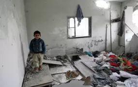 A Palestinian child stands inside his home in the Jabalya refugee camp, damaged during an Israeli incursion and airstrikes which left about 115 Palestinians dead in Gaza over five days.