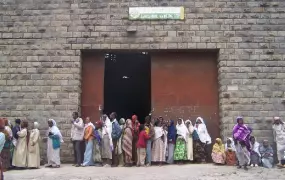 Low-income residents of Addis Ababa queue to buy wheat from a state-owned grain center.