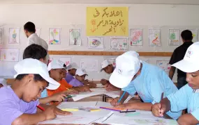 Campers engaging in arts and crafts activities at the Beach Elementary School C&D for Boys in Gaza City, part of the United Nations Relief and Works Agency for Palestine Refugees in the Near East (UNRWA) Summer Games that began last month in Gaza. Drawing