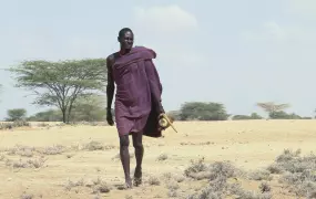 A Turkana man walks across the arid landscape of northwest Kenya, near the town of Lodwar. Many pastoralists in the region have lost animals to drought, theft and disease