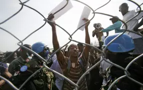 The Sri Lankan Battalion of the UN Stabilization Mission in Haiti provides security at a crowded stadium in Léogâne where WFP and ACTED distribute food to Haitians