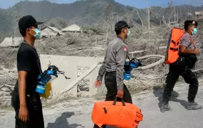 Rescue workers arrive at the scene of the Mount Merapi volcano in central Java. Thousands were forced into emergency shelters when the volcano erupted late in October 2010