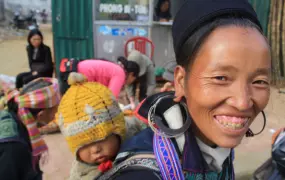 A Black H'mong woman and her child smile to the camera in Sapa, northwestern Vietnam. The French called these ethnic minorities Montagnards ('highlanders' or 'mountain people')