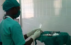 A surgeon prepares for male circumcision at a hospital in Gulu, northern Uganda (Dec 2010)