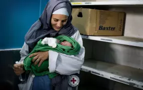 An ICRC nurse holds a newborn baby delivered by caesarean section at Mirwais Hospital in Kandahar, Afghanistan