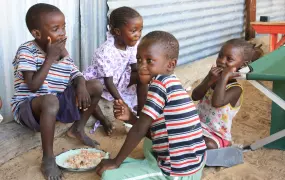 Children in the Haukongo household share their food