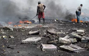 Youths in the Ghana capital Accra burn insulating foam from discarded refrigerators