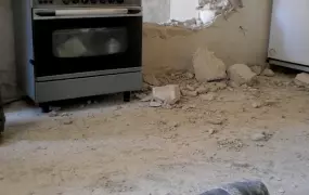 An UXO in a kitchen floor in a damaged apartment in Adjabiya, Libya