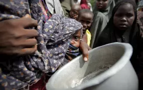 A woman holding her young malnourished baby queues for food at the Badbado camp for Internally Displaced Persons (IPDs)